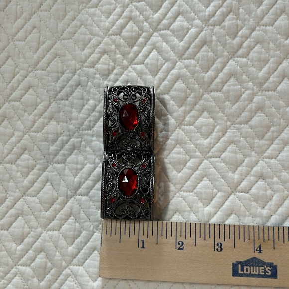 Gunmetal tone stretch bracelet with pretty scrollwork and red stones. - Picture 4 of 4
